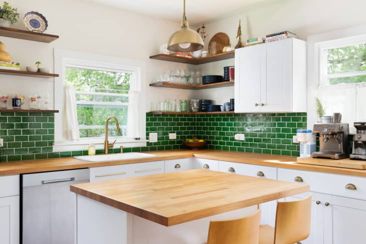 Modern kitchen with wood counters and bright green backsplash