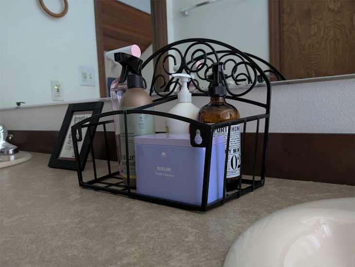 Hose holder used in bathroom as a caddy.