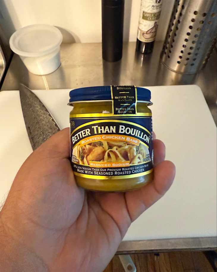 Someone holding jar of Better Than Bouillon.