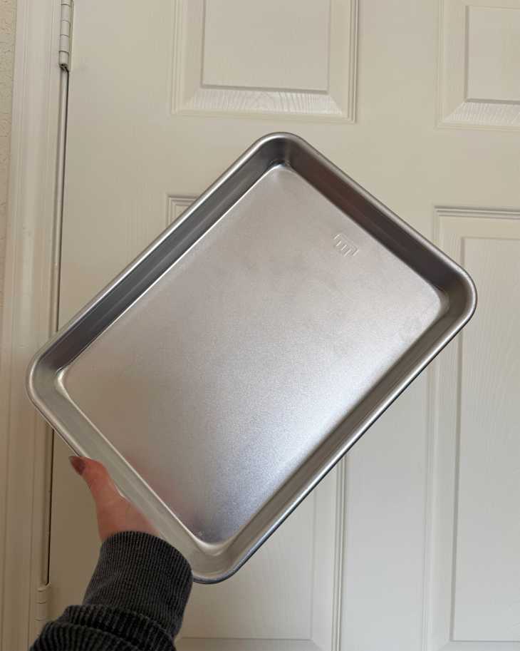 Someone holding up Made In sheet pan.