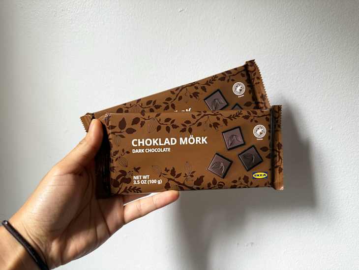 Someone holding up two Ikea chocolate bars.