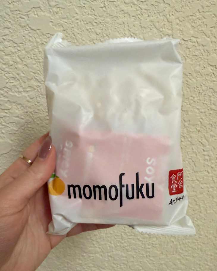 someone holding Momofuku Spicy Soy Noodles in package
