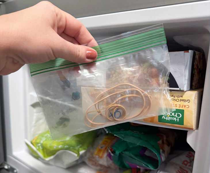 Rubber bands in plastic zip-top bag near freezer.