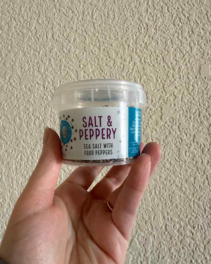 Someone holding Salt and Pepper Cornish Sea Salt Co. in package.