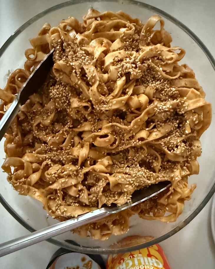 A-Sha noodles in bowl topped with sesame seeds.
