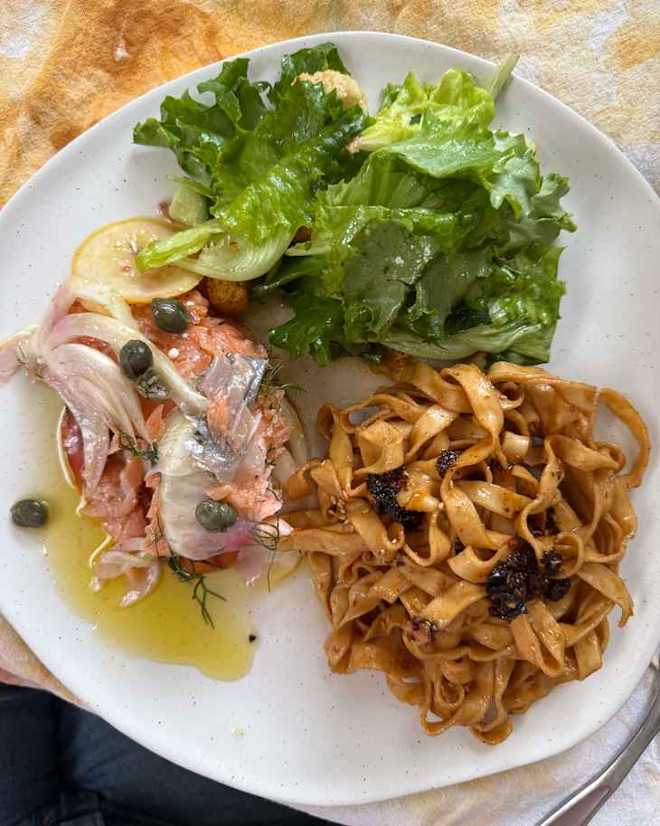 A-Sha noodles on plate with side salads.
