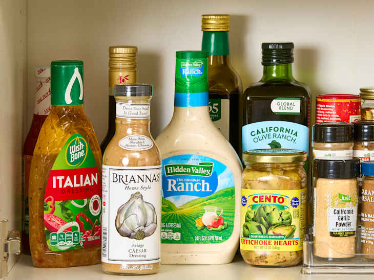 close up shot of assorted bottled pantry items in a cabinet.