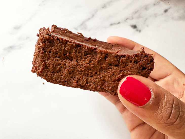 Someone holding cottage cheese brownie.