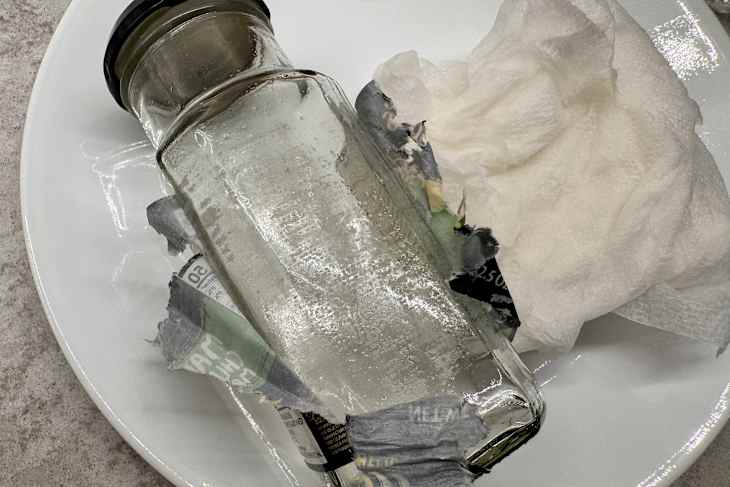 Sticker partially removed on spice bottle .