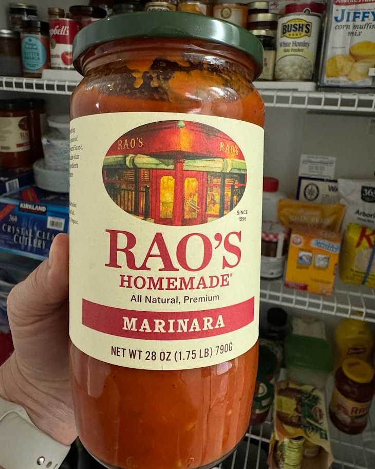 Someone holding Rao's homemade marinara.