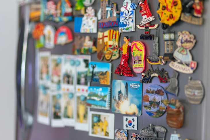 Kota Kinabalu, Sabah, Malaysia-November 10, 2020 : many different travel magnet souvenirs on the fridge.