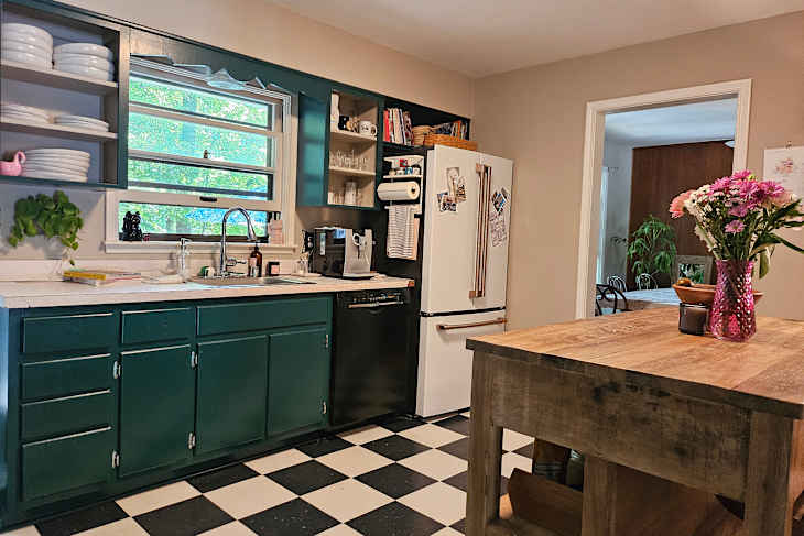 Cabinets painted green in slow remodel kitchen.