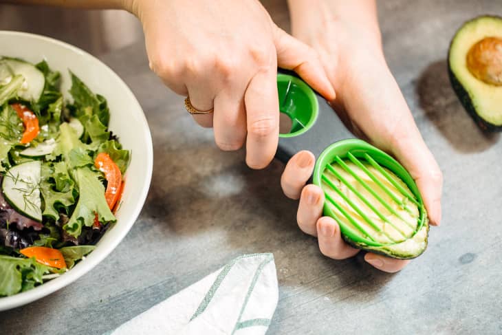 slicing an avocado for a salad