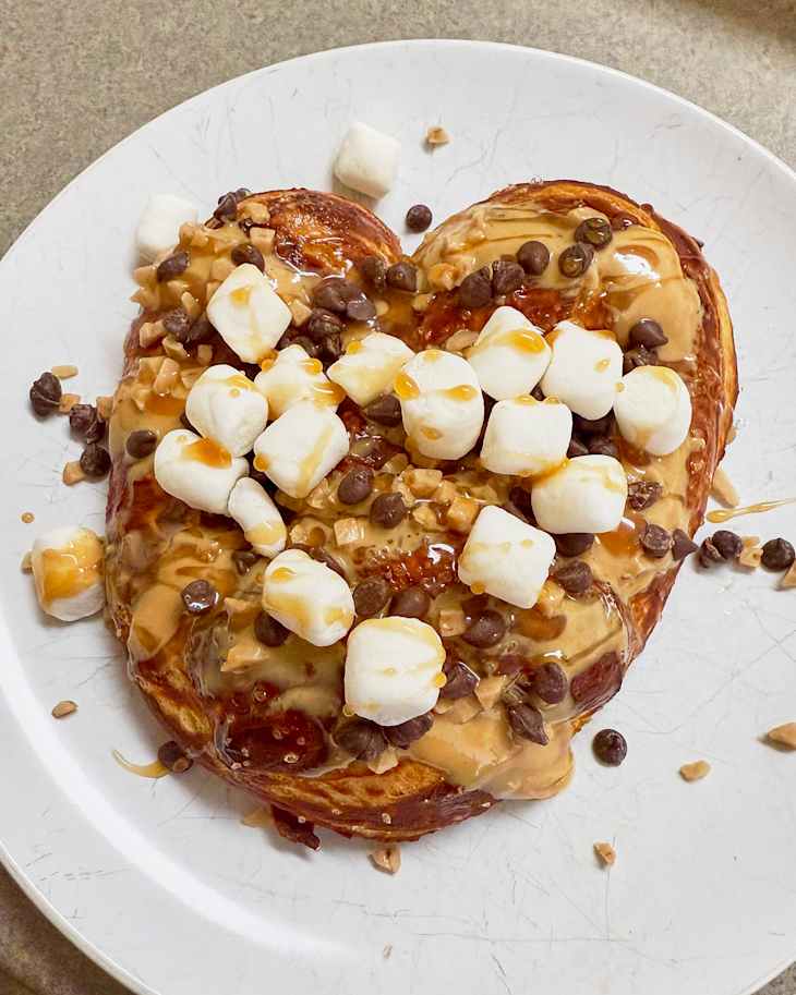 HelloFresh homemade pretzel on a plate with marshmallows, chocolate chips, peanut butter and honey