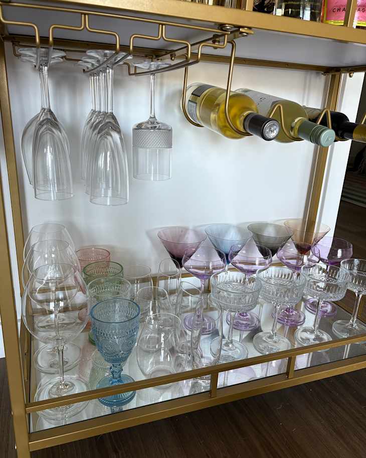 Colorful bar glassware in bar cart.