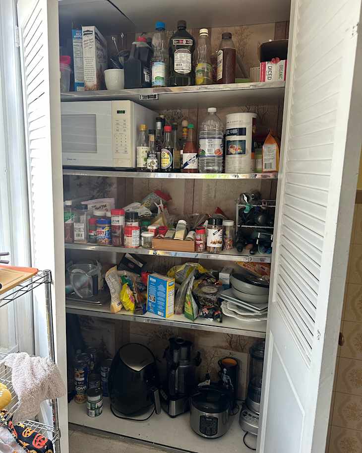 Messy kitchen pantry before using professional organizing advice.