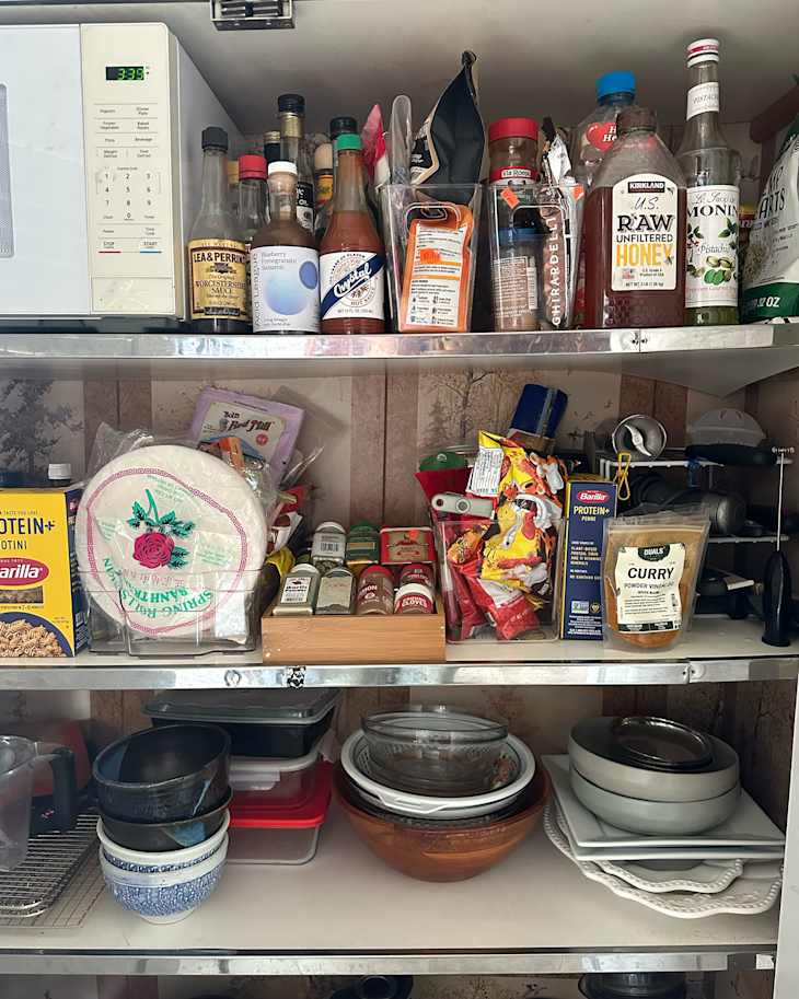 Clear plastic storage in in newly organized kitchen pantry.
