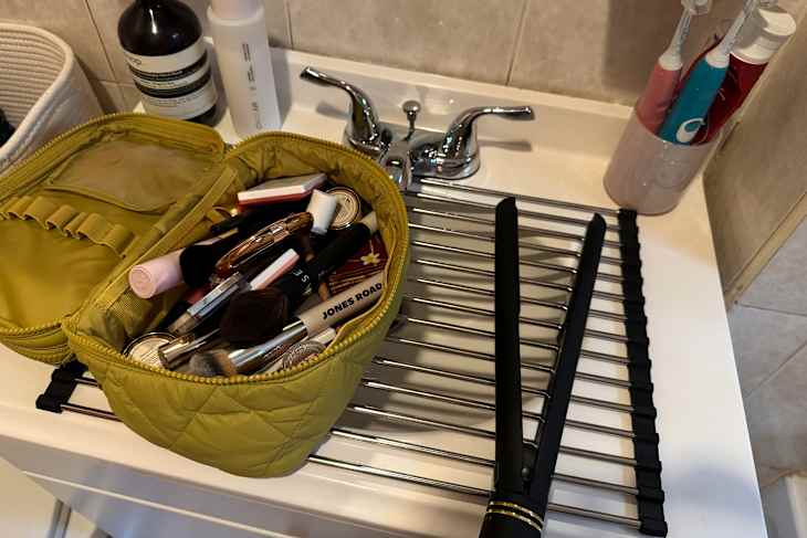 Dish rack on top of bathroom vanity.