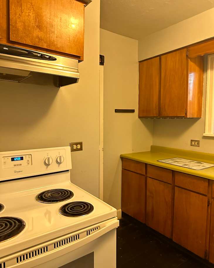 Yellow countertops in vintage kitchen before renovation.