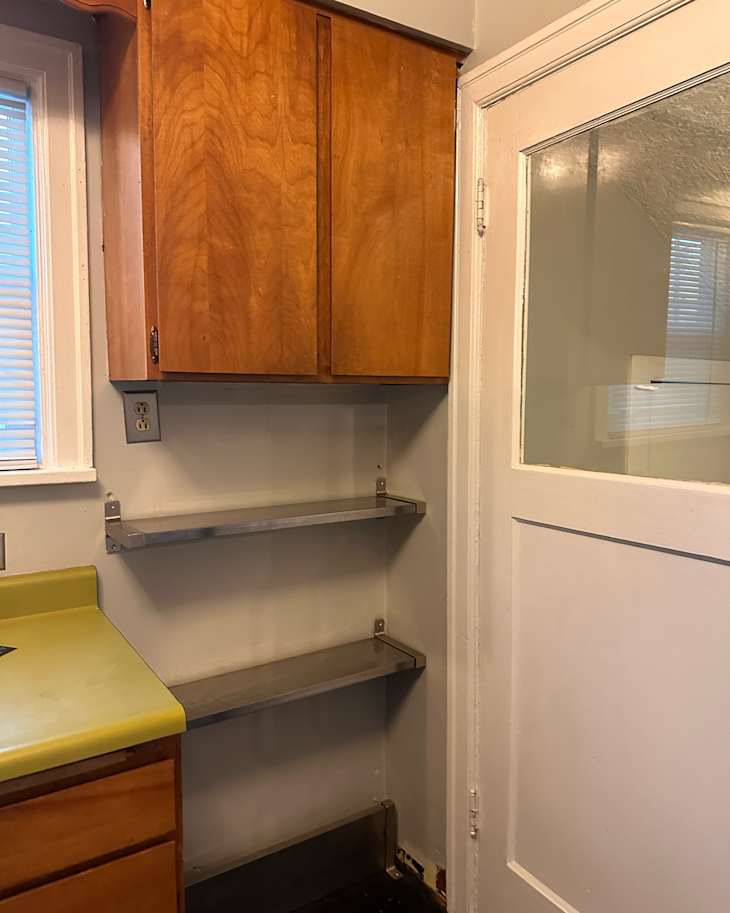 Wooden cabinet in kitchen before renovation.