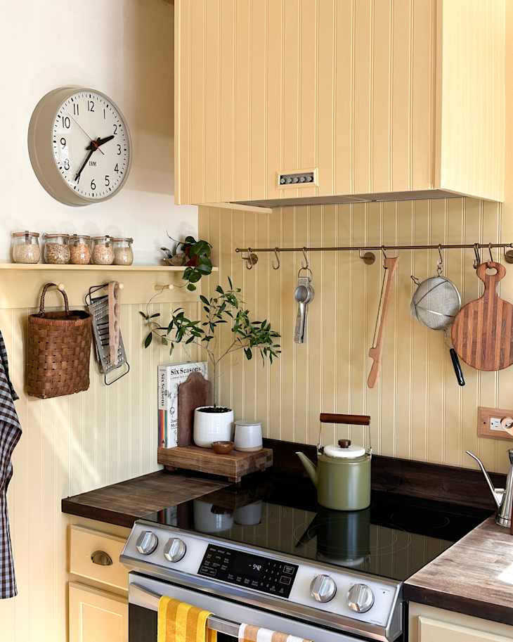 Yellow painted wainscoting backsplash in kitchen renovated kitchen.