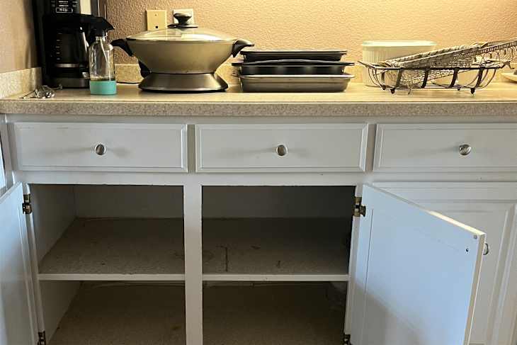 Kitchen supplies on countertop after clearing out cabinets.