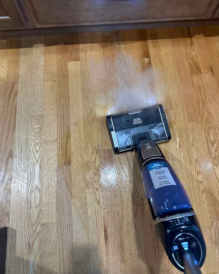 Someone using Shark 3-in-1 steam vac.
