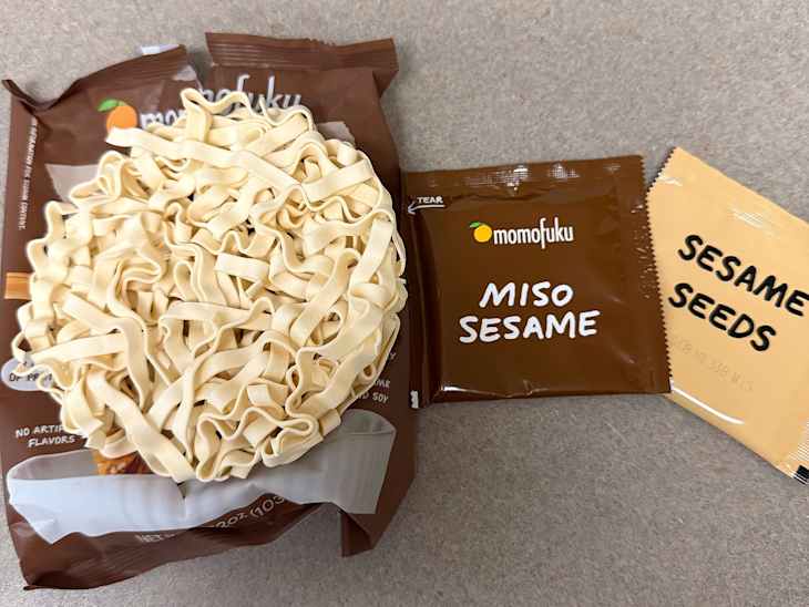 Momofuku Sesame Miso Noodles with package open so we can see noodles, seasoning packets