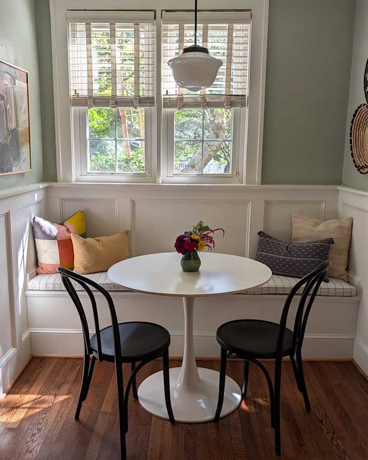 White bistro table in kitchen nook after being staged.