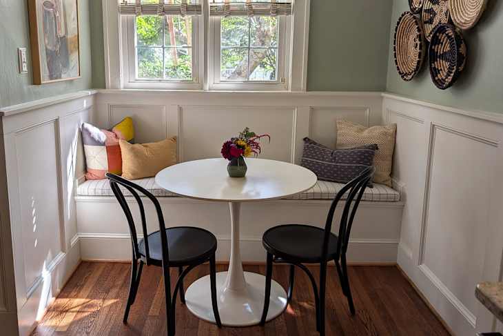 White bistro table in kitchen nook after being staged.