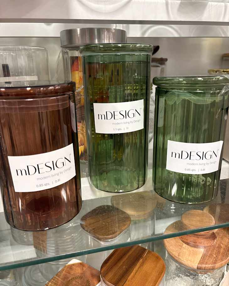 Colorful glass jars on store shelves.