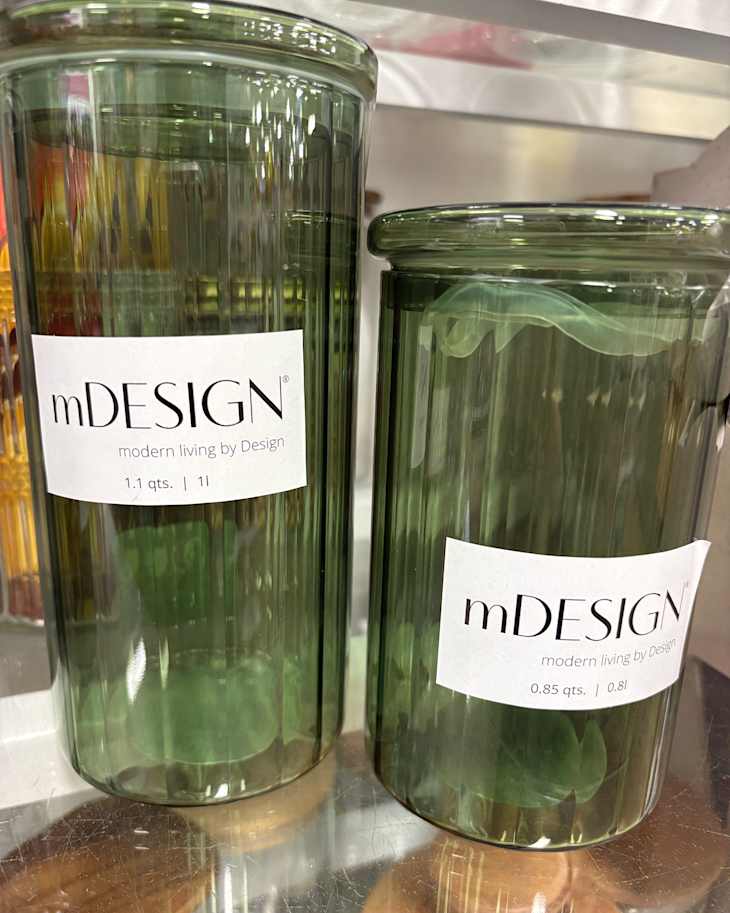 Labels on glass jars on store shelf.