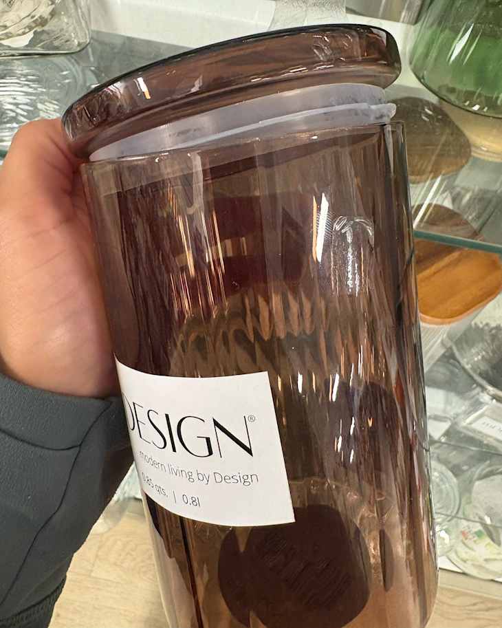 Someone holding glass jar in T.J Maxx store.