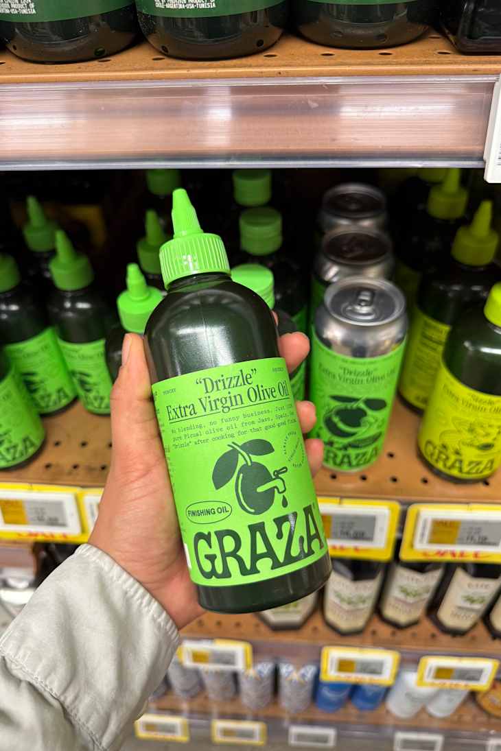 A green bottle of "Drizzle" Extra Virgin Olive Oil