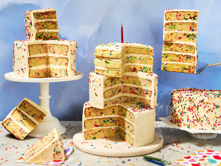 Layered birthday cakes with colorful sprinkles, a slice on a plate, and a red candle on top.