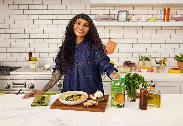 Sophia Roe in the kitchen with ingredients, including Pacific Chicken Broth