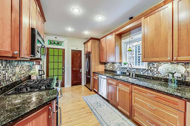 Wooden cabinets in kitchen before renovation.