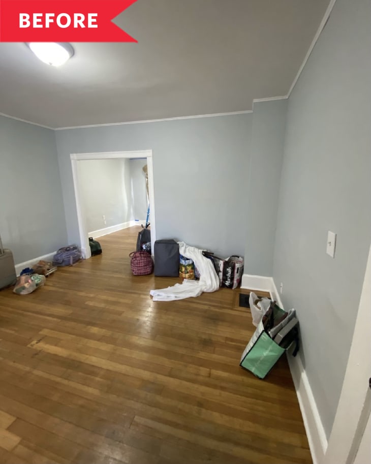 Before: Living room with soft blue walls mostly empty except for bags around the perimeter
