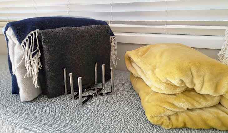 Using plate and lid organizers to store blankets.