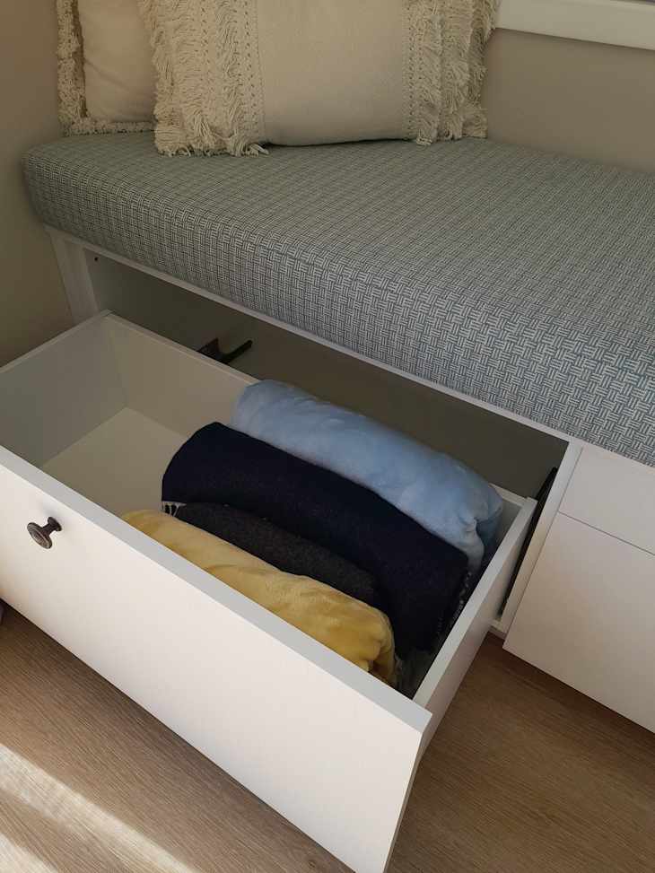 Using plate and lid organizers to store blankets.