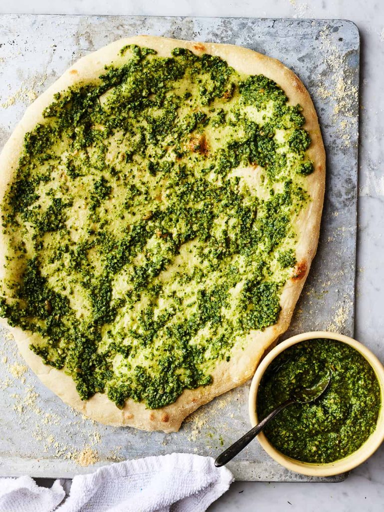 Pizza topped with Pesto Sauce