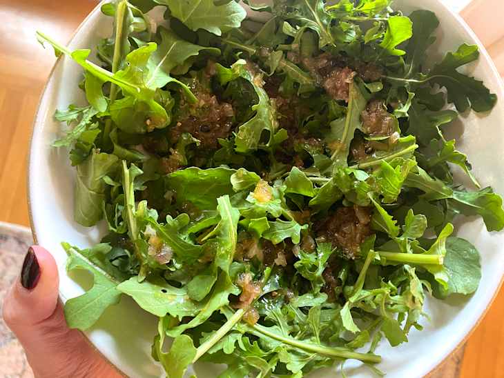 Salad dressing drizzled over lettuce.