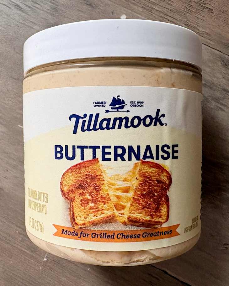 Container of Tillamook Butternaise, a blend of butter and mayonnaise, with toasted bread graphic and text.