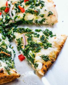 Gourmet Spinach Pizza featuring High-Quality Toppings