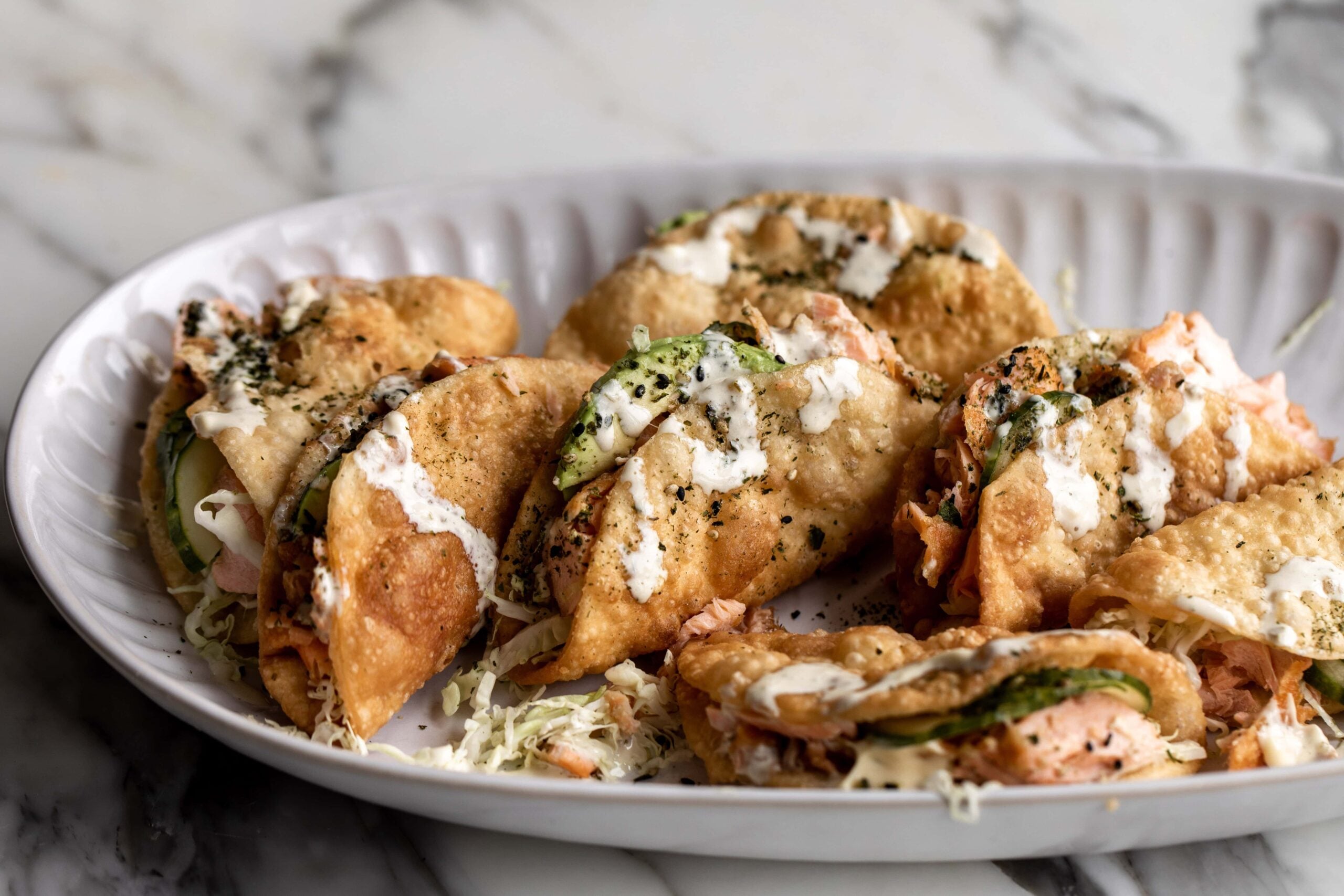 Tacos Stuffed with Salmon and Drizzled with Creamy Avocado Sauce