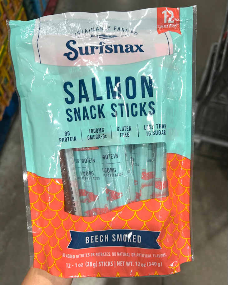 Sustainable salmon snack sticks in a colorful package, highlighting protein content and gluten-free label.