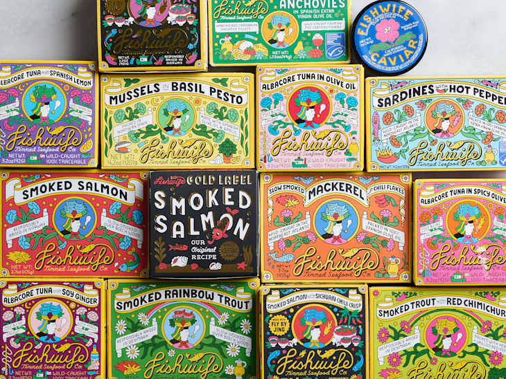 Colorful assortment of Fishwife canned seafood products, including smoked salmon, mackerel, and sardines.