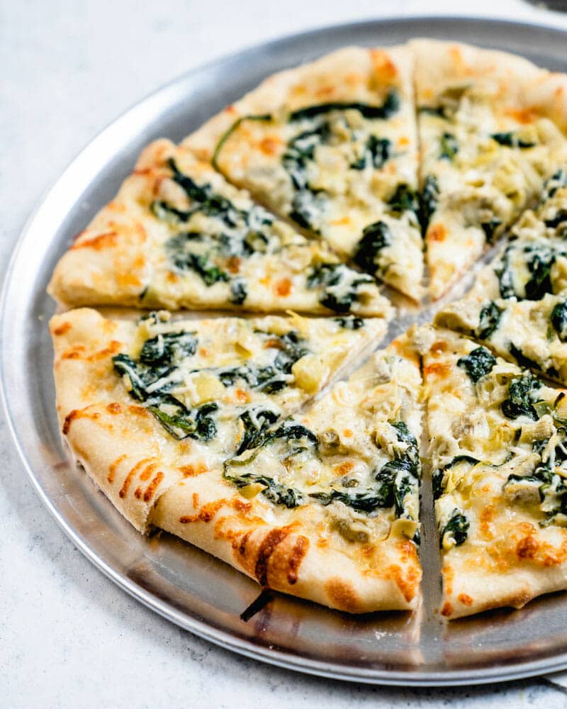 Pizza topped with Spinach and Artichokes
