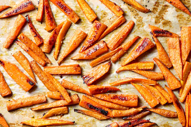 overhead shot of miso butter glazed carrots on a sheet pan.