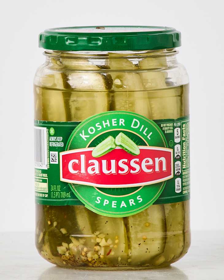Jar of Claussen Kosher Dill Spears pickles with visible spears and spices in brine.